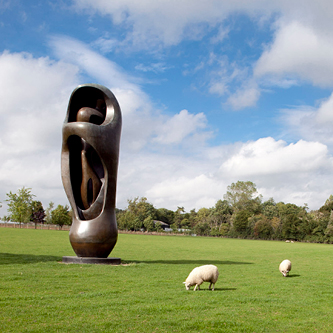 Landscape with large sculpture and sheep